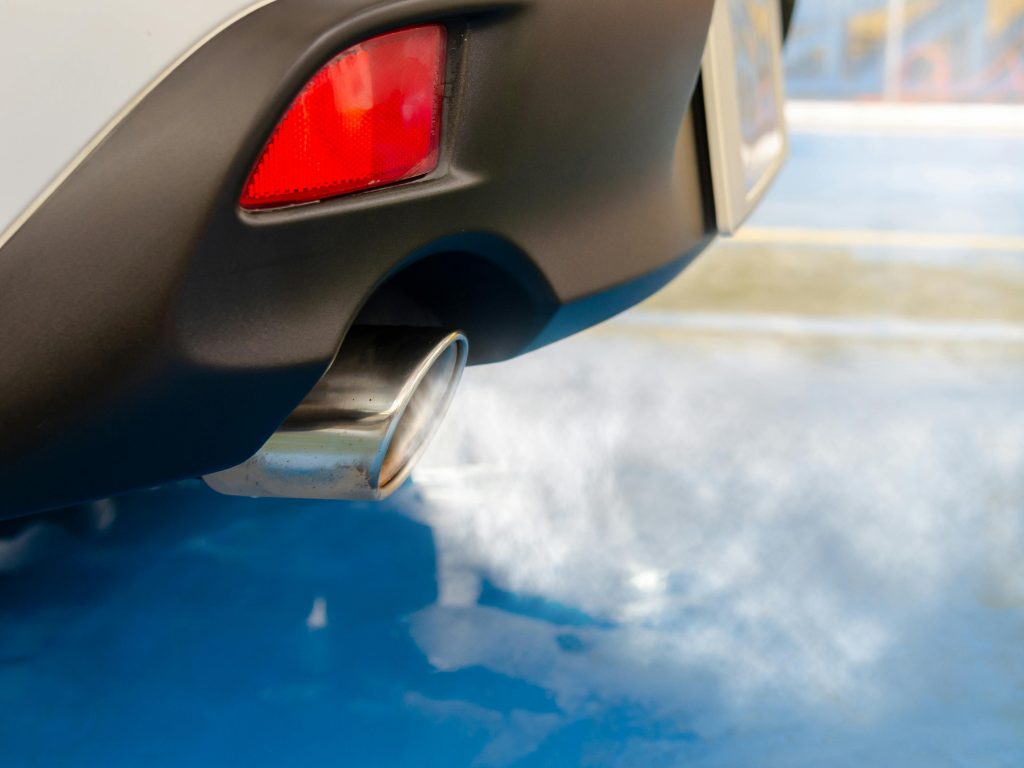 Close-up photo of a car exhaust spilling fumes